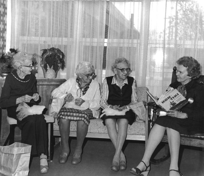 Thelma Pepper reading to care home residents